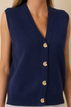 Navy blue knit sweater vest with gold shell buttons, side view