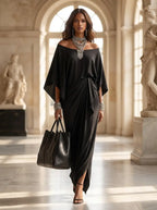 Model wearing the black asymmetric-cut maxi dress