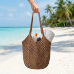 Crochet mesh tote bag carried by a woman in a bright summer setting